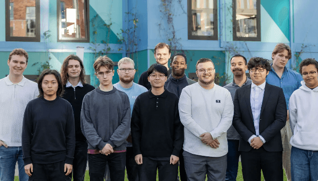 Group of people smiling and collaborating outdoors